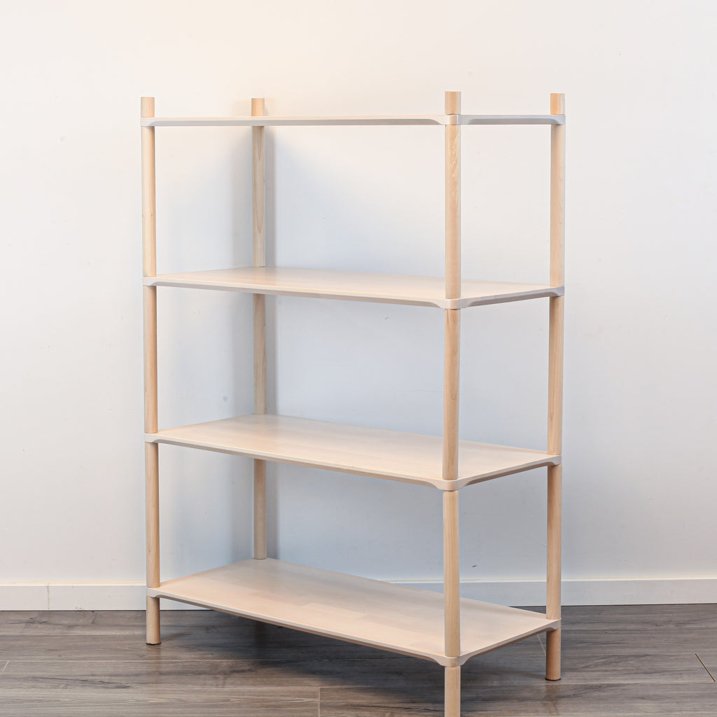 One Little Pine Medium 4-Shelf Montessori-Inspired Wooden Shelving Unit shown from an angled view, highlighting the open shelves at child height.