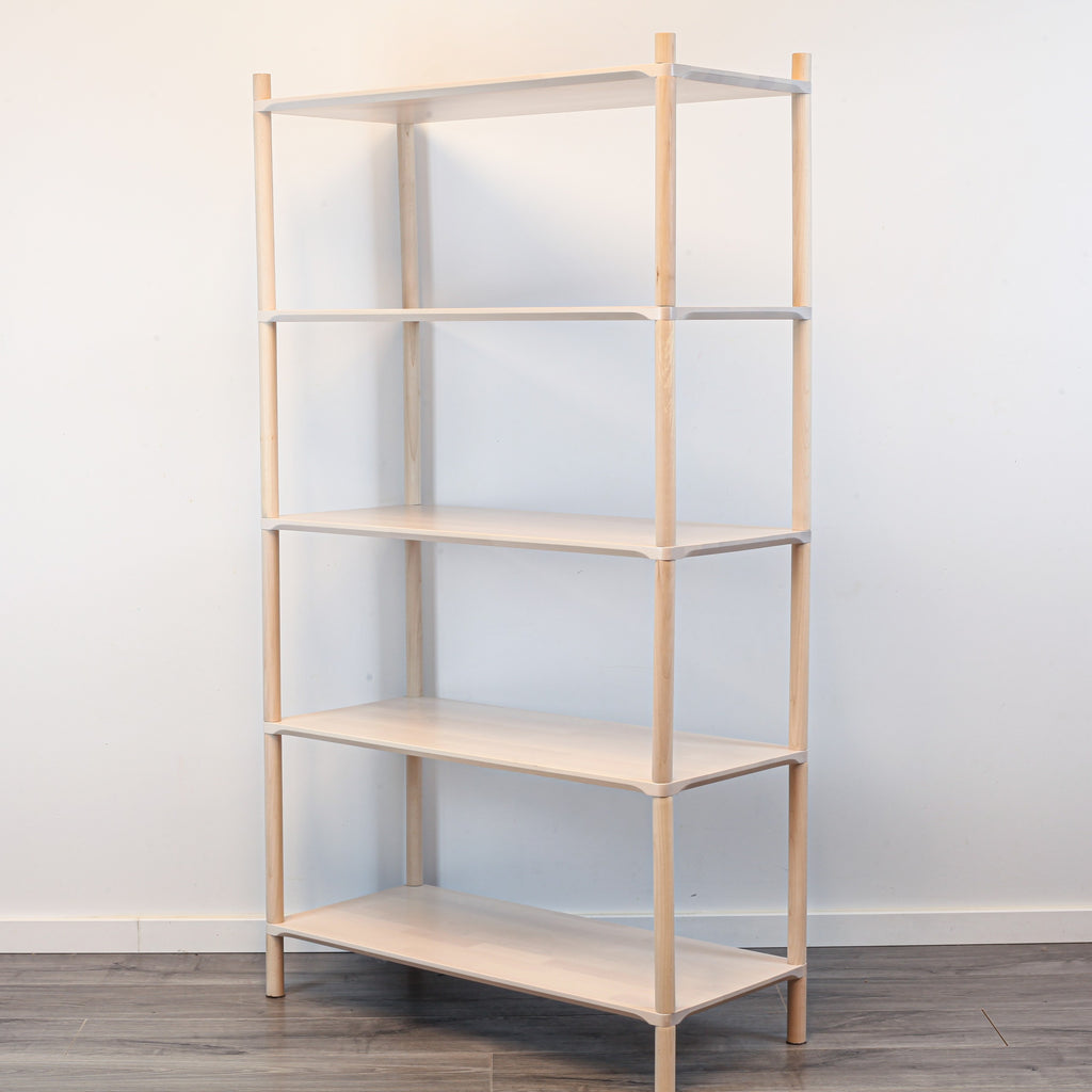 One Little Pine Medium 5-Shelf Montessori-Inspired Wooden Shelving Unit shown from an angled view, highlighting the open shelves at child height.